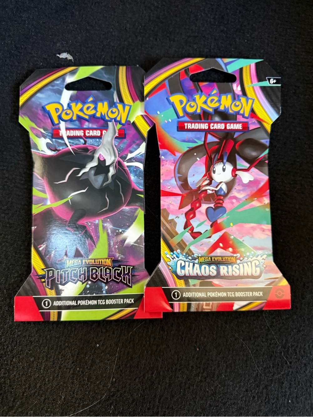 2 Pokemon Booster Packs - Black, Pink, Green & Blue Artwork